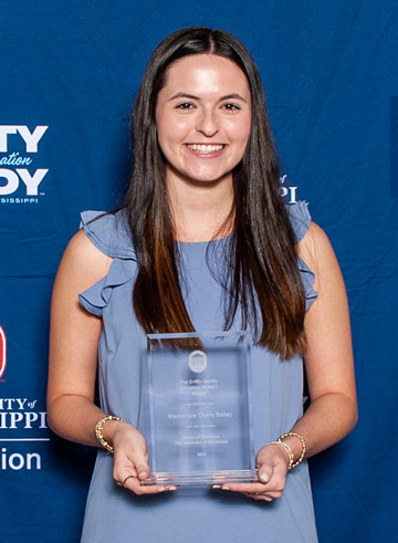 Person holding award.