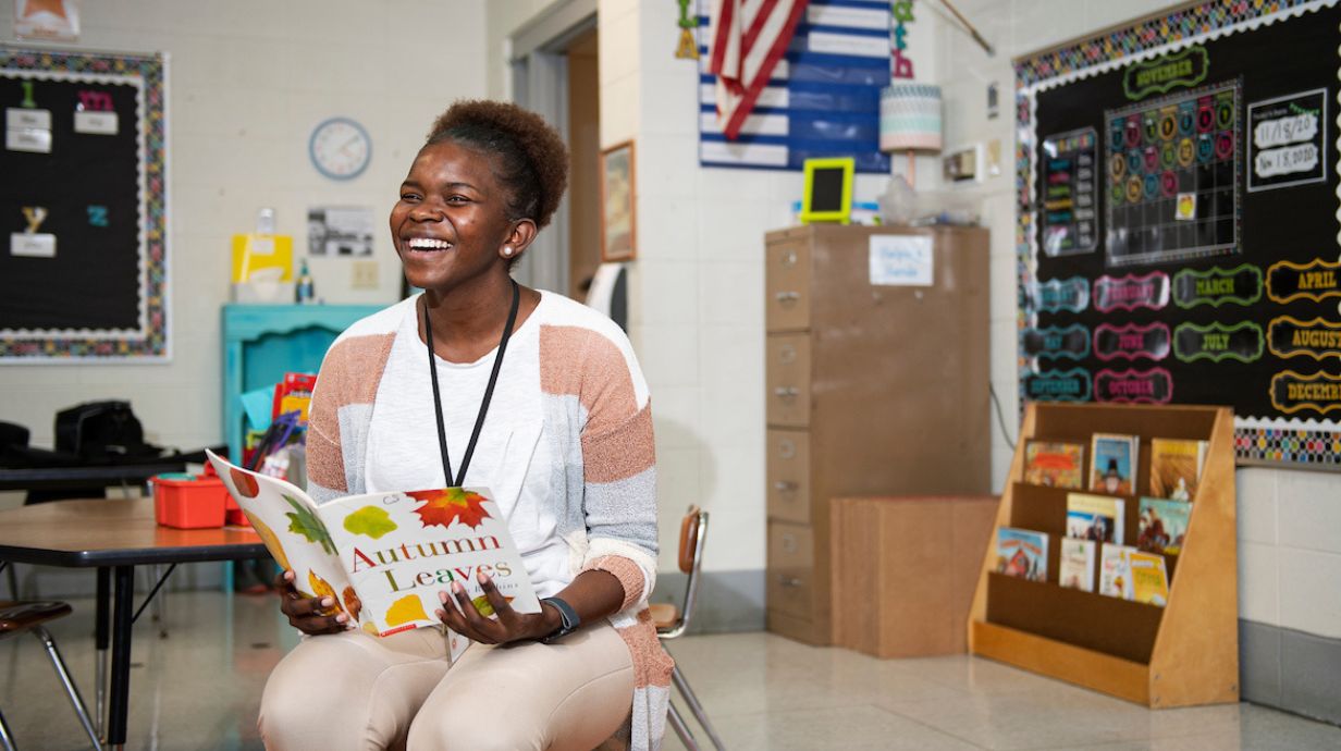 Certificate in Early Childhood and Family Policy - Teacher reading a book.