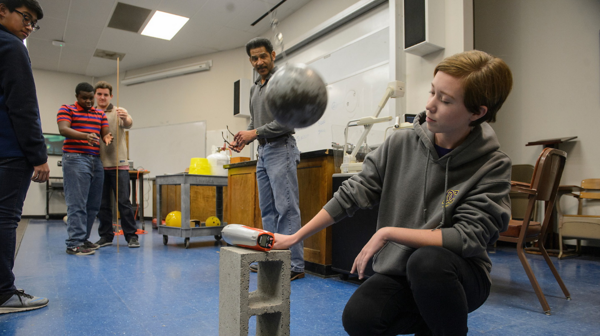 Teacher uses technology and props in the STEM classroom.