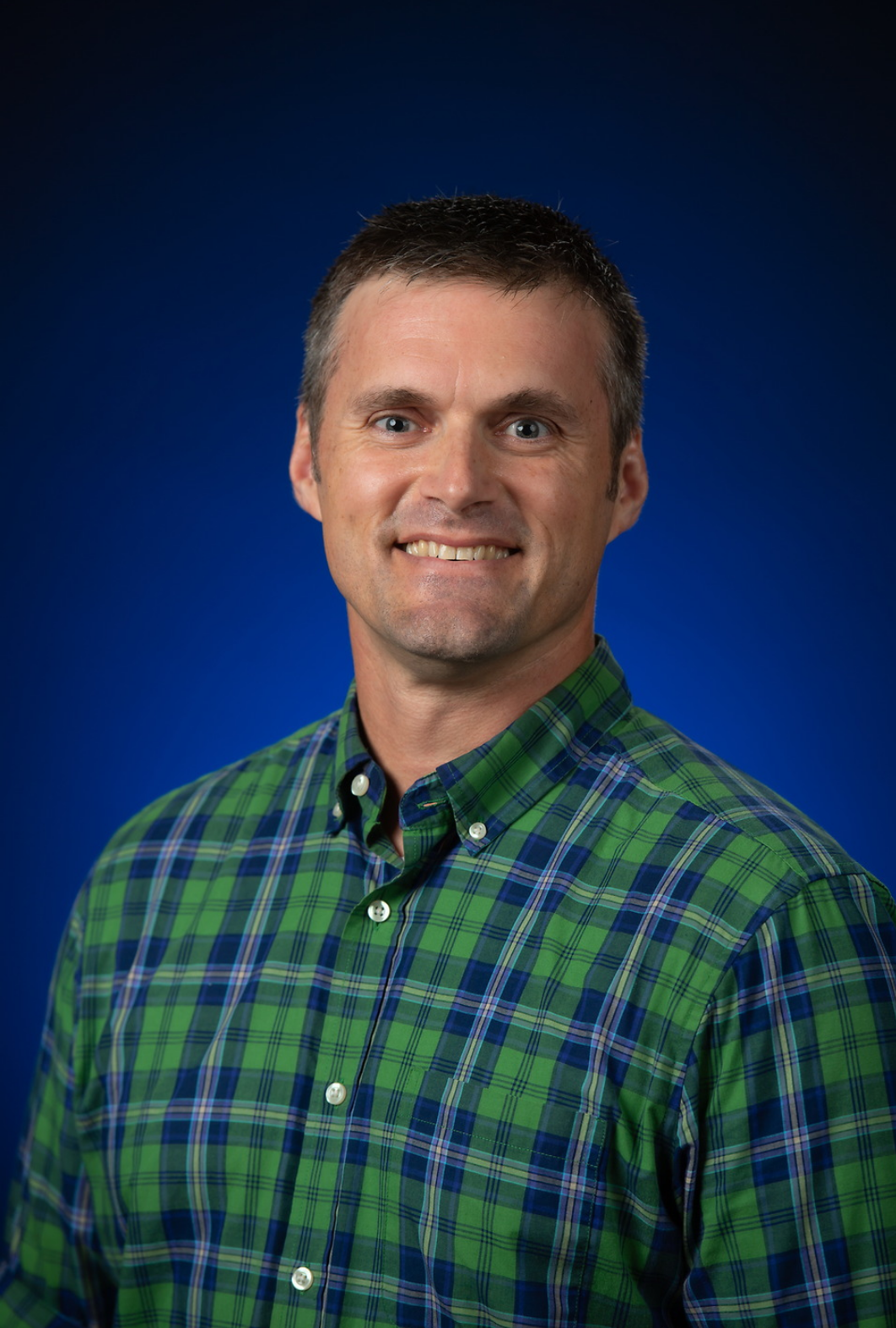 Amidon, Professor of Teacher Education, smiles for a professional headshot.