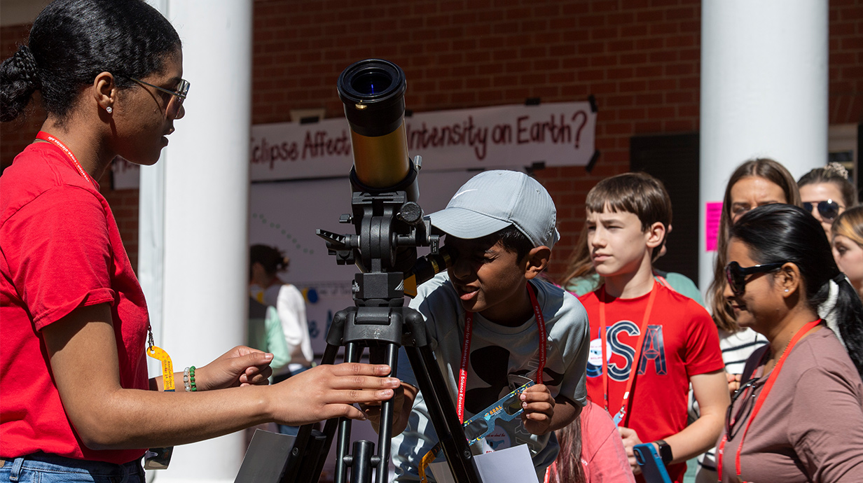 Bachelor of Arts in Science Education student looking through telescope