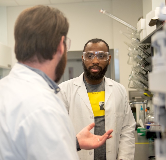 Biomedical engineering students consult on their work in the research lab.