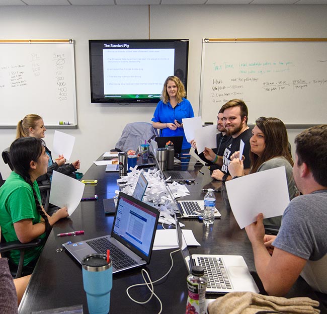 Chemical engineering students participate in an exercise with an employee of Cooper Tire.