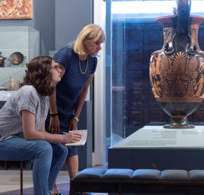 image of student and faculty member viewing an ancient vase in the museum