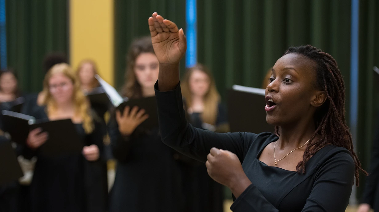 image of a woman conducting the choir