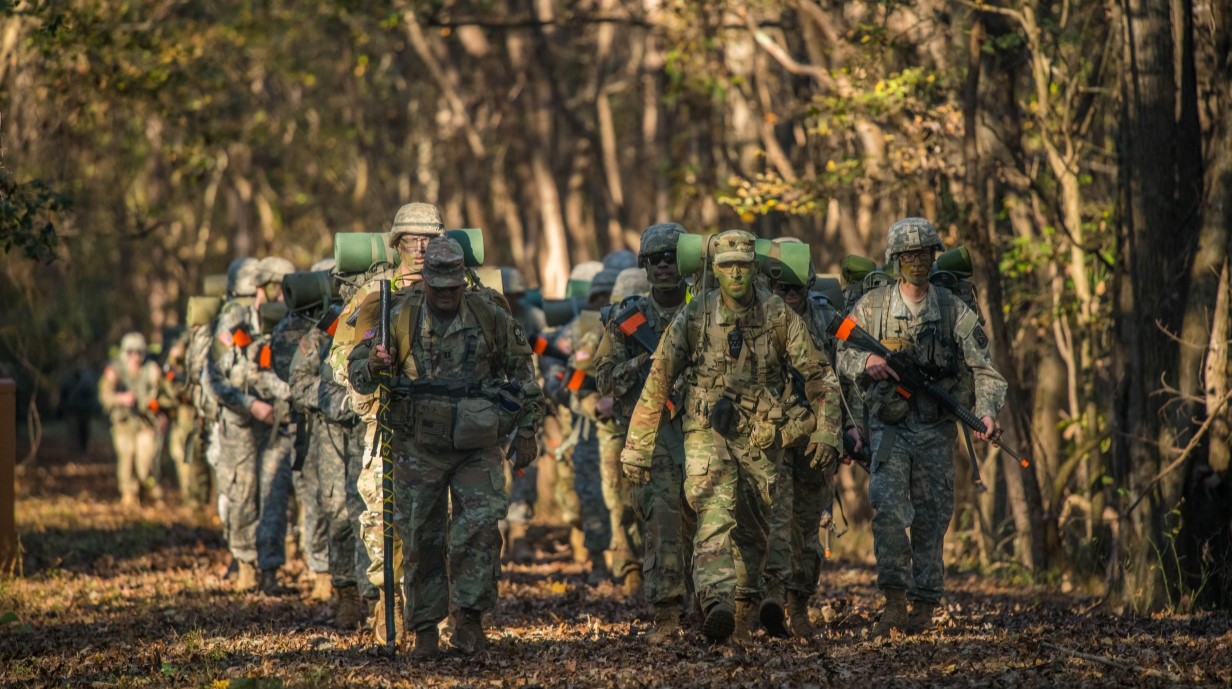 image of army cadets in fatigues on a run through the woods