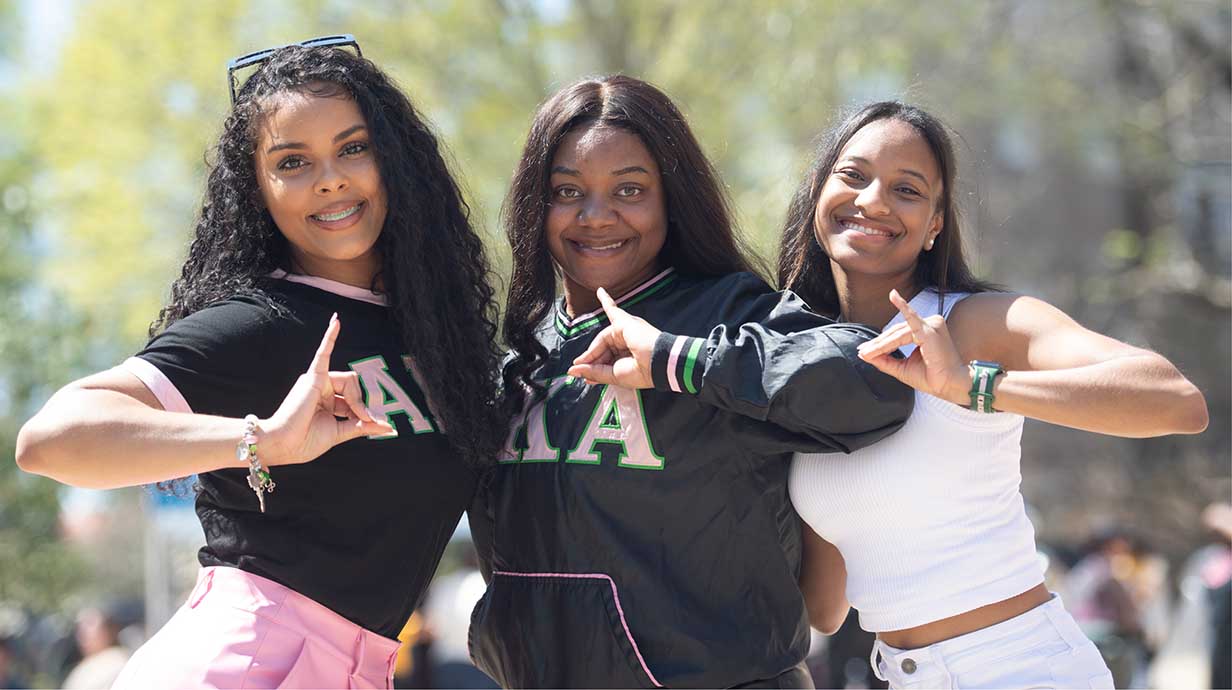 Members of Alpha Kappa Alpha Sorority, Inc. pose for a group photo in front of the Ole Miss student union.