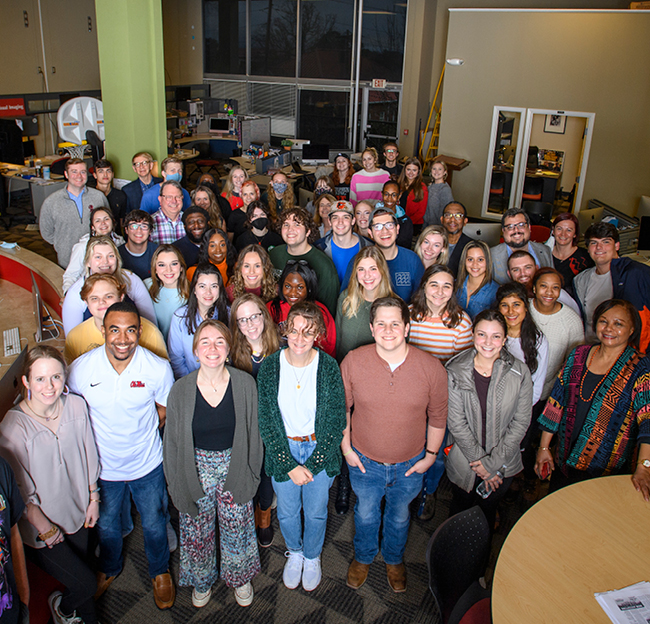 Student workers pose for a group photo at the S. Gale Denley Student Media Center