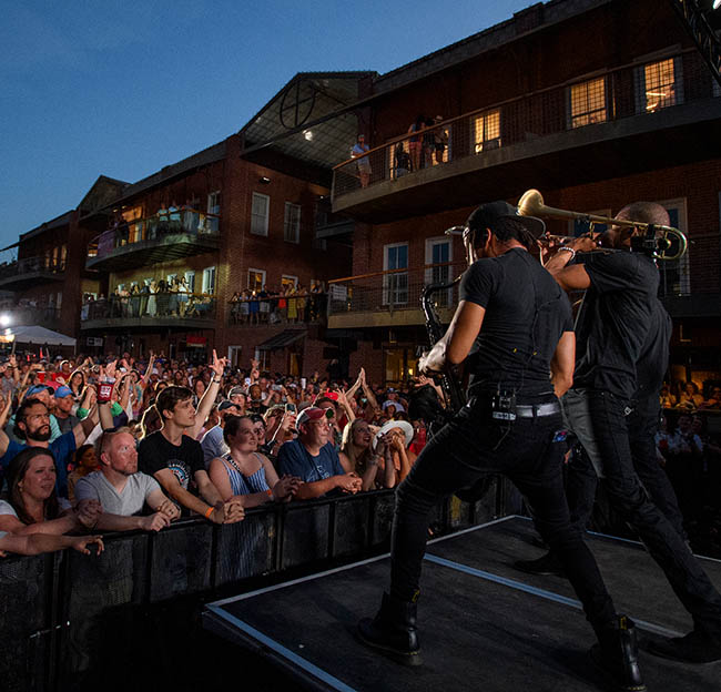 Band playing on a stage at a music festival