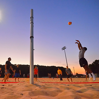 students playing beach volleyball