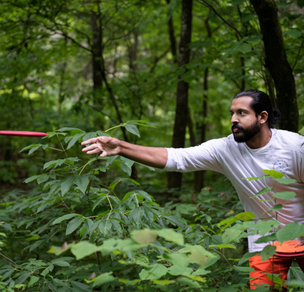 Male playing disc golf