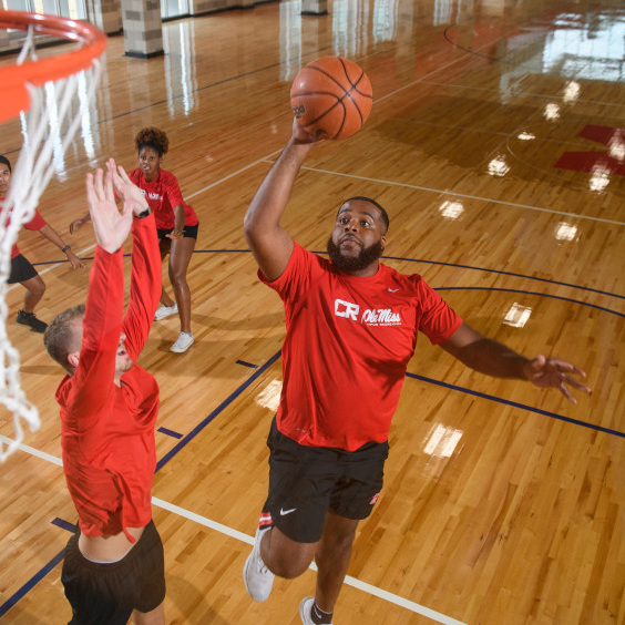 men playing basketball in a gym