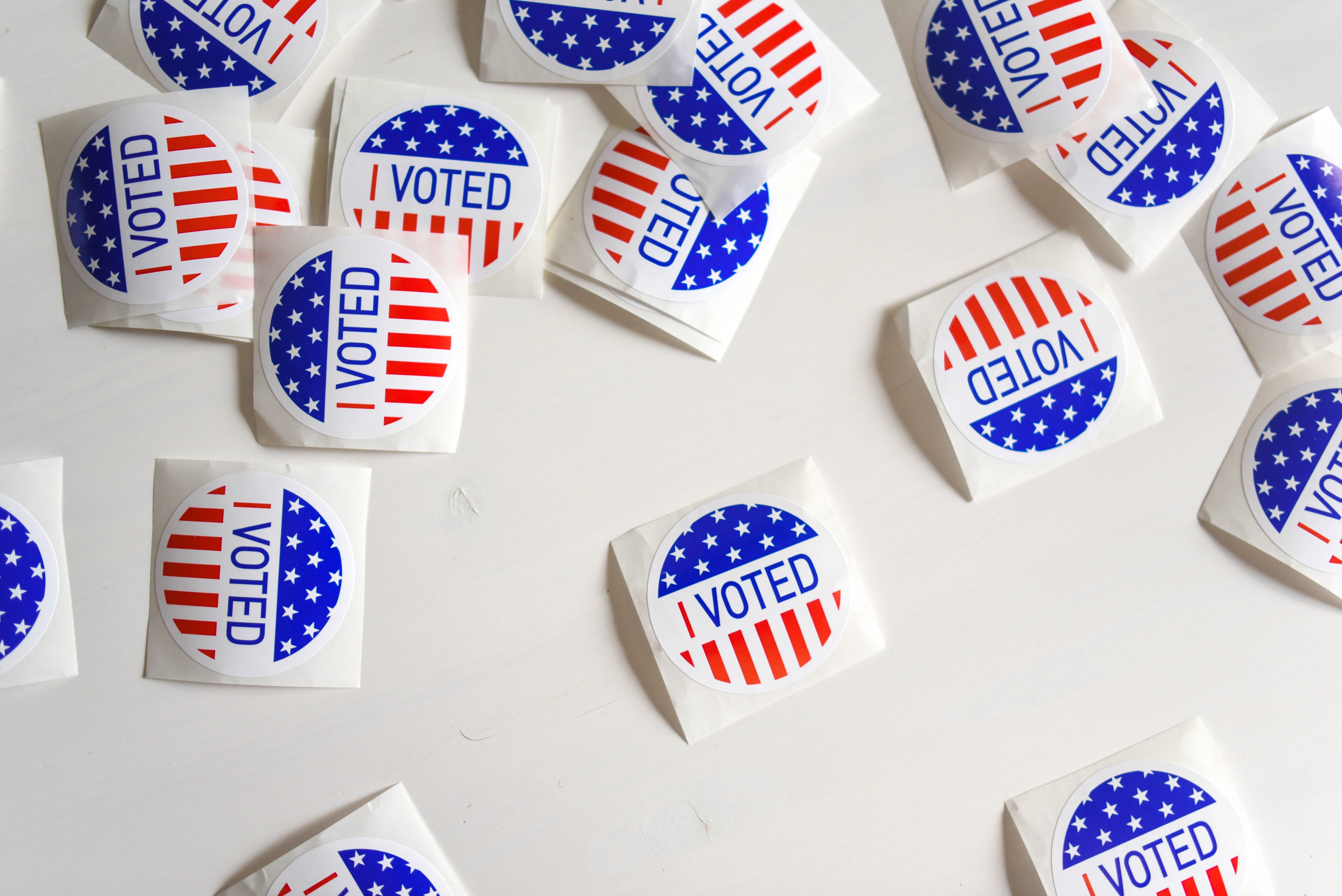 I voted stickers scattered across a table.